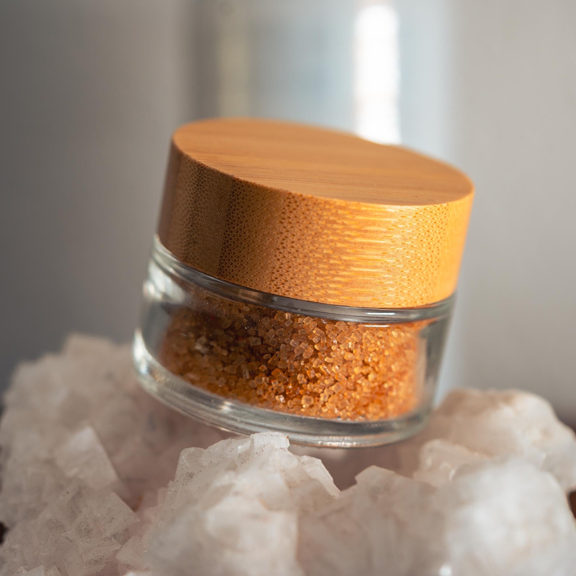Glass jar with wooden lid on a crystal base
