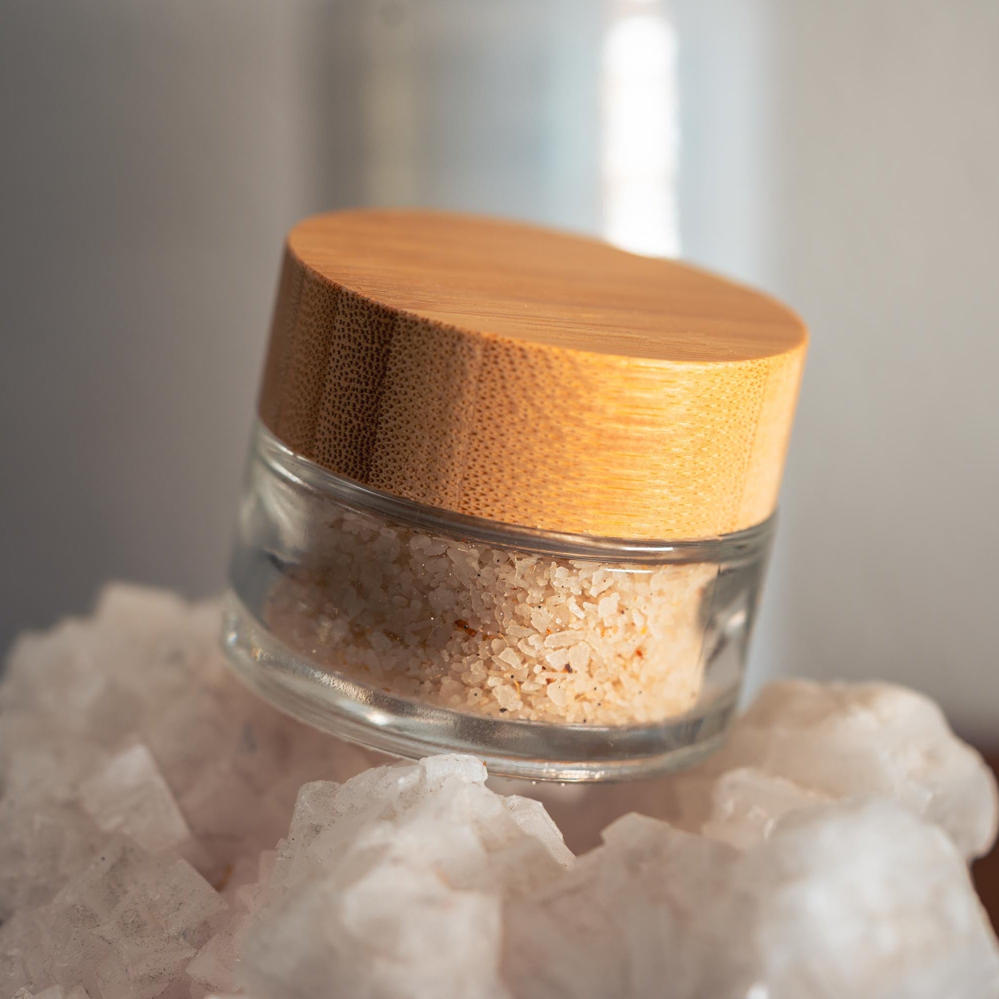 Glass jar with wooden lid on a white rock