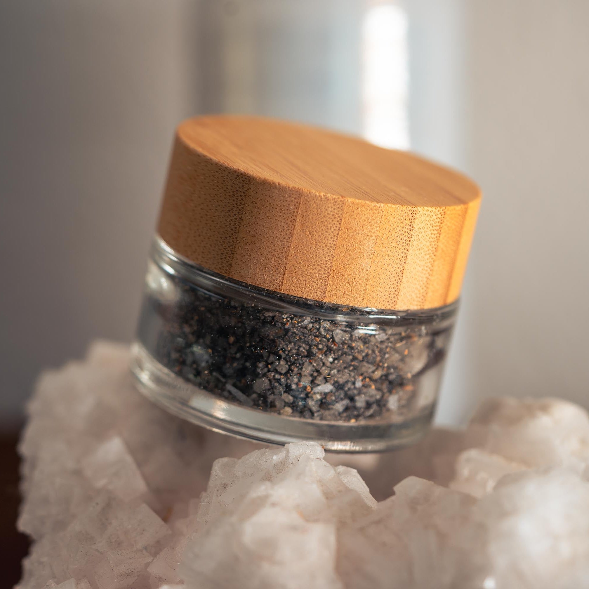 Glass jar with wooden lid on a crystal base